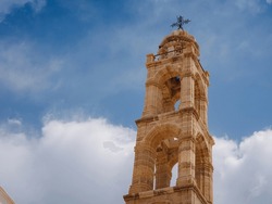 travel to city of Lindos on island of Rhodes, Greece. St. Mary of Lindos Church over blue sky with white clouds. tourist attraction on island of Rhodes