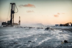 Drilling rig works on the Arctic island.