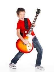 A young white boy sings and plays on the electric guitar with bright emotions, isolated on white background