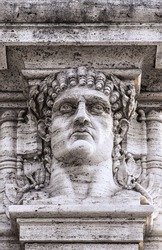 A statue relief of emperor Nero's head on the gateway entrance to the park that contains the ruins of his golden palace at domus aurea in Rome.