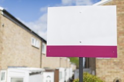 Blank placard sign outside a row of terraced houses