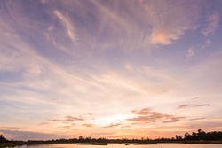 Sunset sky background with landscape of calm lake at sunset 
