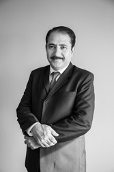 Black and White portrait of a old middle age business man with a moustache wearing a suit and tie 