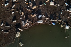 Aerial drone view waterfront scrap-heap plastic bottles rubbish pollution marine debris outdoors, environmental ecological natural disaster caused by human activity, ecosystems terrible state concept