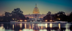 Panoramic image of the Capitol of the United States with the capitol reflecting pool in morning light.