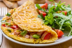 Delicious Egg Omelet with Ham and Vegetables on the Plate