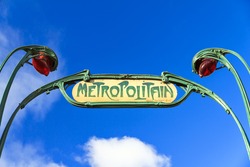 Retro subway sign in Paris, France, with a blue sky