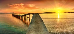 Sunrise over the sea. Pier on the foreground. Panorama