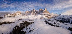 aerial view of Pale di San Martino and Passo Rolle covered with snow in winter, Trento,  Italy