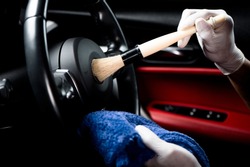 Car detailing series, Man use brush cleaning on hand wheel.