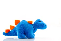 Blue dinosaur plush toy isolated on white. This dinosaur doll also called stegosaurus