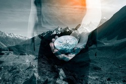 Double exposure image of snow mountain and male hands with hiking compass.