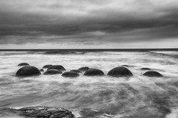 Moeraki Boulders on the Koekohe beach, Eastern coast of New Zealand. HDR image, black and white