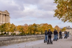 Tour groups of tourists on the streets of Paris in the autumn of Segway