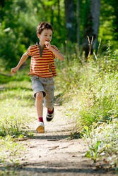 Young boy running in nature