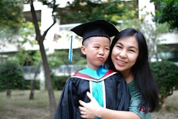 Mother congratulates her child on graduating from kindergarten Mom's love, parent hugging child, kid graduation, succeed concept