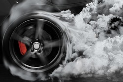 Sport car burns tires with drifting and smoking on track in preparation for the race.