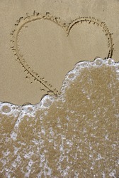 heart semi cleared by the foam of a wave