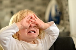 Portrait of crying baby girl. 