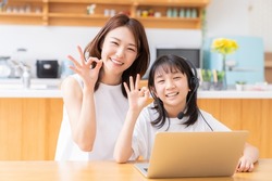 asian girl studying with a PC,correspondence course, mother and daughter