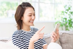Young attractive Asian woman using a smart phone