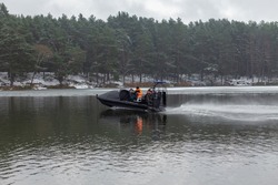 A rescue team is sailing on a hovercraft to rescue fishermen on the frozen lake, river or sea. The boat can move equally on water, on ice and even on land.
