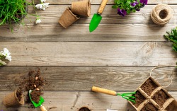 Gardening tools on wooden background. Spring garden works concept. Flat lay, top view