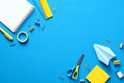 School supplies on blue background. Flat lay, top view. Back to school concept.