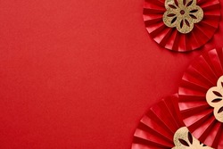 Happy Chinese New Year banner template. Traditional festival paper fans with gold flowers on red table.