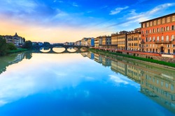 Florence, Ponte alla Carraia medieval Bridge landmark on Arno river, sunset landscape with reflection. It is the second oldest bridge, built in 1218, in the city. Tuscany, Italy.