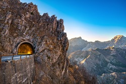Alpi Apuane mountain road pass and tunnel view at sunset. Movie location in Carrara, Tuscany, Italy. Europe.
