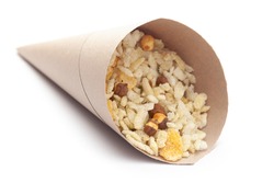 Close-Up of Crunchy Diet Mixture In handmade ( handcraft ) brown paper cone bag made with Puffed Rice, Corn Flakes, and Curry leaves. Indian spicy snacks (Namkeen),