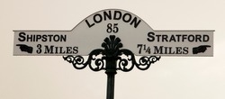 A ornate vintage road sign showing London 85 miles away, Stratford (on Avon) 714 miles in one direction and Shipston 3 miles in the other.