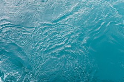 Blue sea surface with waves and ripples. Top view