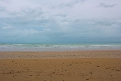 Overcast Cable Beach, Broome, North Western Australia on a late cloudy humid dull afternoon in the summer Wet Season is reflected in the stormy waves and brooding skyscape.