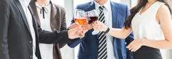 Diversity Business People Celebration Toast with red wine after meeting with great deals at office. Multi Ethnic Businessman and Businesswoman. Congratulating, Cheers, Party time. Banner, Panoramic.
