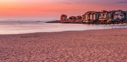SOZOPOL, BULGARIA - SEPTEMBER 11, 2013: sunrise on sandy city beach in mellow season. Beautiful and warm weather on the shores of Black sea.