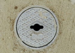 Close up photo of a gray outdoor faucet cover