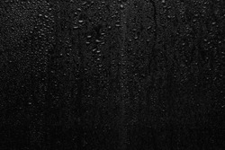 Part of series. Background photo of rain drops on dark glass, different size: small medium and large horizontal view