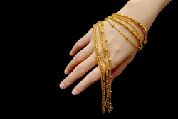 woman hand hold group of gold necklace jewelry isolate on black
