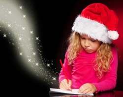 Child writing a magic letter to santa claus. Little girl