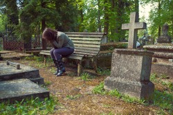 A woman mourns in the cemetery