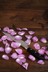 butcher knife with pink rose petals