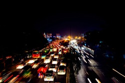 Delhi, India. Heavy car traffic in the city center of Delhi, India at night. Illuminated car trails
