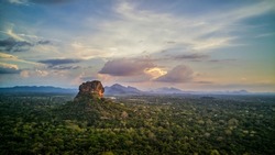 Sunset over the Lion Rock in Sigiriya, Sri Lanka. Aerial view of the tropical forest with mountains