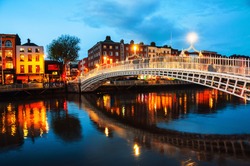 Dublin, Ireland. Night view of famous illuminated Ha Penny Bridge in Dublin, Ireland