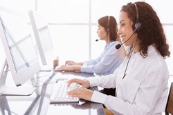 Callcenter people working calling for helpdesk hotline or Telesale agent. Customer support happy working with smile in office record customer data in CRM software. 