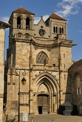 The facade of the Saint Peter and Saint Paul church of the Benedictine priory of Souvigny (the sign at the bottom of the photo is a map of the village)