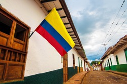 A street in Barichara, Colombia with Colombian flags.