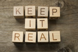 keep it real text on a wooden background